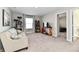Bright living room featuring a comfortable couch, a cat tree, a bookshelf, and a window for natural lighting at 28 Lively Pl, Cicero, IN 46034