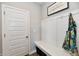 Mud room featuring a white bench with storage, coat hooks, and a door. A cheerful sign hangs on the wall at 28 Lively Pl, Cicero, IN 46034