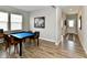 Spacious game room featuring a table, wood flooring, and a view into the entry way at 28 Lively Pl, Cicero, IN 46034