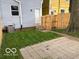 View of the backyard featuring a patio and a wooden gate at 342 N Arsenal Ave, Indianapolis, IN 46201