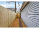 A view down the side of the house along a new wooden fence at 342 N Arsenal Ave, Indianapolis, IN 46201