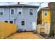 Backyard featuring blue siding, a new wooden fence, and a grassy area at 342 N Arsenal Ave, Indianapolis, IN 46201