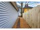 A view down the side of the house along a new wooden fence at 342 N Arsenal Ave, Indianapolis, IN 46201