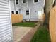 View of the backyard, with a concrete patio and grass area by the fence at 342 N Arsenal Ave, Indianapolis, IN 46201