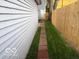 A view of the backyard area, with a narrow brick walkway along the fence at 342 N Arsenal Ave, Indianapolis, IN 46201