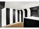 Unfinished basement features carpet flooring and black and white striped walls at 342 N Arsenal Ave, Indianapolis, IN 46201
