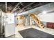 Unfinished basement with utility equipment, stairs, washer, dryer and door at 342 N Arsenal Ave, Indianapolis, IN 46201