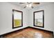 Empty bedroom with hardwood floors and two windows allowing for natural light at 342 N Arsenal Ave, Indianapolis, IN 46201