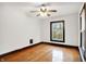 A spacious bedroom features a window and a ceiling fan, enhanced by hardwood floors at 342 N Arsenal Ave, Indianapolis, IN 46201
