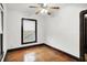 Bright bedroom featuring hardwood floors, a ceiling fan, and natural light from the window at 342 N Arsenal Ave, Indianapolis, IN 46201