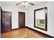 A bedroom features a window with blinds, hardwood floors and paneled doors and trim at 342 N Arsenal Ave, Indianapolis, IN 46201