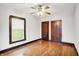 Charming bedroom features wood floor, ceiling fan, and a window letting in natural light at 342 N Arsenal Ave, Indianapolis, IN 46201
