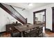 Dining area with modern table and chairs, with entry to the living room, and stairway access at 342 N Arsenal Ave, Indianapolis, IN 46201