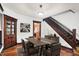 Dining room with dark wooden trim, hardwood floors, and access to the stairs and kitchen at 342 N Arsenal Ave, Indianapolis, IN 46201