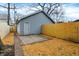 Detached garage, new wooden fence, brick path, and grassy area at 342 N Arsenal Ave, Indianapolis, IN 46201