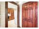 Hallway with wood door leading to a kitchen with wooden cabinets and appliances at 342 N Arsenal Ave, Indianapolis, IN 46201
