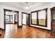 Living room with hardwood flooring featuring a partial view into another room with windows at 342 N Arsenal Ave, Indianapolis, IN 46201