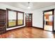 Living room featuring hardwood floors, a charming built-in cabinet, and access to the kitchen at 342 N Arsenal Ave, Indianapolis, IN 46201