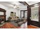 Bright living room with a decorative fireplace, hardwood floors, and neutral furniture at 342 N Arsenal Ave, Indianapolis, IN 46201