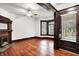 Spacious room with hardwood floors, a decorative fireplace, and large windows, offering classic charm at 342 N Arsenal Ave, Indianapolis, IN 46201