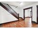 A staircase in the living room of this home has hardwood flooring and original trim details at 342 N Arsenal Ave, Indianapolis, IN 46201
