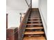Classic wooden staircase with dark trim leading to the upper level at 342 N Arsenal Ave, Indianapolis, IN 46201
