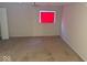 Carpeted basement area with white trim, window with red shade, and neutral colored walls at 4050 Harmony Dr, Indianapolis, IN 46221