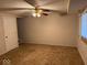 Spacious basement area with neutral carpet, ceiling fan, and natural light from the window at 4050 Harmony Dr, Indianapolis, IN 46221