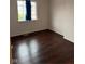 Cozy bedroom featuring hardwood floors and ample natural light from a bright window at 4050 Harmony Dr, Indianapolis, IN 46221
