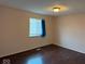 Comfortable room featuring hardwood floors, fresh paint, and lots of natural light at 4050 Harmony Dr, Indianapolis, IN 46221