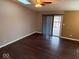 Inviting room featuring hardwood floors, fresh paint, and a sliding glass door at 4050 Harmony Dr, Indianapolis, IN 46221
