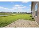 Spacious backyard featuring a patio, green grass and a pond at 4236 Stubbington Ln, Indianapolis, IN 46239