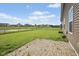 Spacious fenced backyard featuring a brick patio and a view of a pond at 4236 Stubbington Ln, Indianapolis, IN 46239