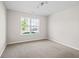 Bright bedroom with a large window and neutral colored carpet at 4236 Stubbington Ln, Indianapolis, IN 46239