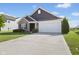 Charming home with a two-car garage, brick accents, and a well-maintained lawn and landscaping at 4236 Stubbington Ln, Indianapolis, IN 46239