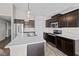 Modern kitchen features stainless steel appliances, a large island, and dark wood cabinetry at 4236 Stubbington Ln, Indianapolis, IN 46239