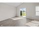 Bright, empty living room with luxury vinyl flooring and a sliding glass door at 4236 Stubbington Ln, Indianapolis, IN 46239
