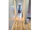 Hallway featuring hardwood floors and access to multiple rooms at 5212 Bahia Dr, Indianapolis, IN 46237