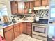 Efficient kitchen with stainless steel appliances, custom backsplash, and ample cabinet space at 5212 Bahia Dr, Indianapolis, IN 46237