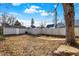 Backyard with the decorative fire pit, garage, and partial fencing under a bright sky at 529 W 42Nd St, Indianapolis, IN 46208