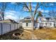 Exterior view of a backyard with mature trees, an ornamental fire pit, and white fencing at 529 W 42Nd St, Indianapolis, IN 46208