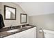 Bright bathroom features double sinks with granite countertops and framed mirrors at 529 W 42Nd St, Indianapolis, IN 46208