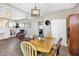 Inviting dining area with stylish lighting, wood table, and a glimpse into the bedroom at 529 W 42Nd St, Indianapolis, IN 46208