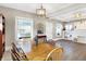 Charming dining room with wood table, lots of sunlight and view to front porch at 529 W 42Nd St, Indianapolis, IN 46208