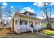 Charming home featuring a welcoming front porch with white railings and a neatly maintained lawn showcasing neighborhood charm at 529 W 42Nd St, Indianapolis, IN 46208