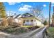 Inviting home with a quaint front porch, complemented by mature trees and a long driveway in a serene setting at 529 W 42Nd St, Indianapolis, IN 46208