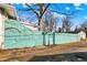 A charming, painted backyard fence adds a touch of art and privacy to the property at 529 W 42Nd St, Indianapolis, IN 46208