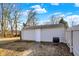 A detached garage with a white door and siding, complemented by a black grill at 529 W 42Nd St, Indianapolis, IN 46208