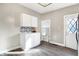 Bright kitchen features white cabinets, mosaic backsplash, modern lighting and a door to the outside at 529 W 42Nd St, Indianapolis, IN 46208