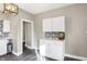 Charming kitchen featuring bright white cabinets, stylish mosaic backsplash, and modern lighting fixture at 529 W 42Nd St, Indianapolis, IN 46208